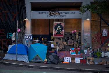 OpenGraph image for kuow.org/stories/we-know-who-made-the-call-to-seattle-police-s-east-precinct-last-summer-finally