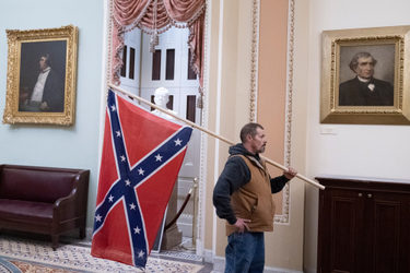 OpenGraph image for vice.com/en/article/bvx5a8/the-guy-who-flew-a-confederate-flag-in-the-capitol-has-predictably-surrendered